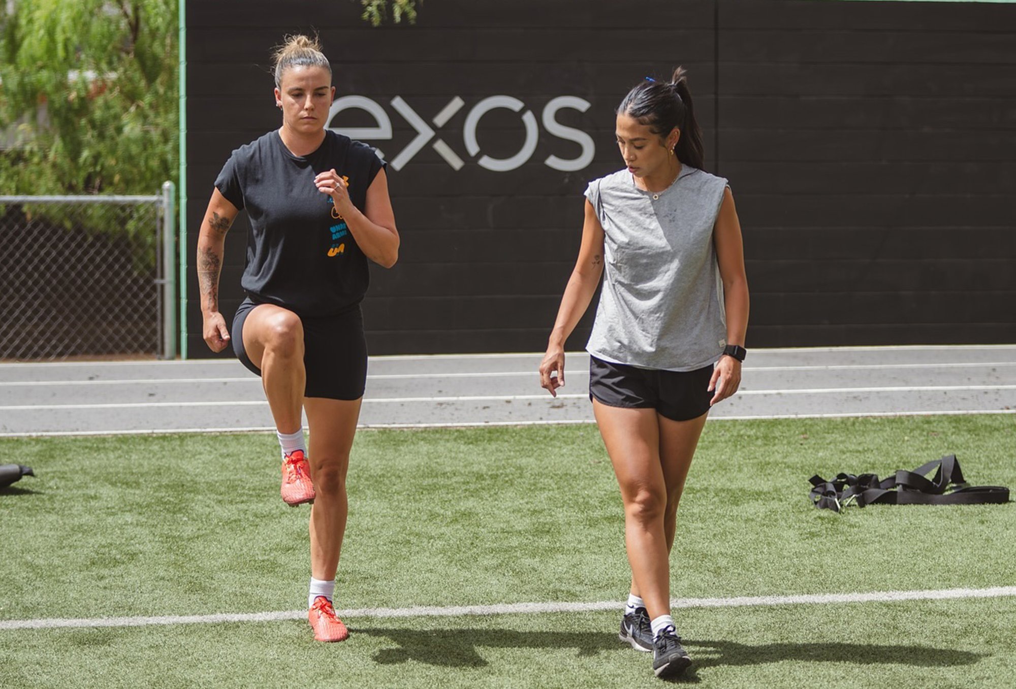 Coach Pauline training an athlete at an Exos facility.