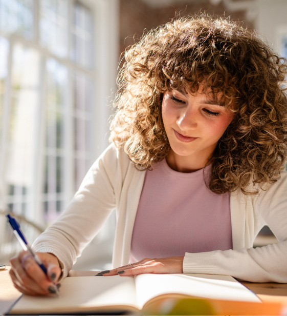 Focused employee writing in a notebook, illustrating flow state at work where concentration boosts performance.