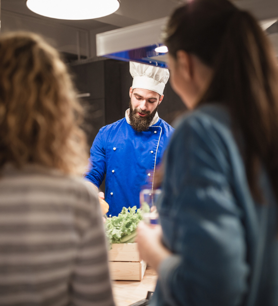 Chef leading a healthy cooking demo for employees, supporting workplace wellness and nutrition education.