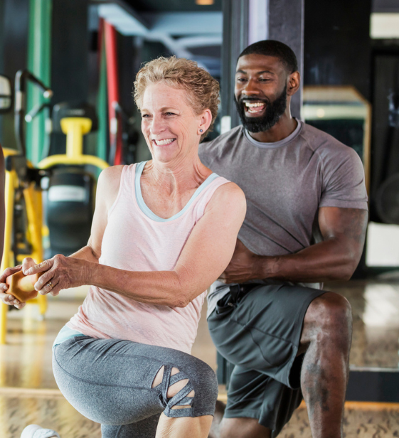 Employee trains with Exos coach in a workplace fitness center, building confidence, health, and long-term performance.