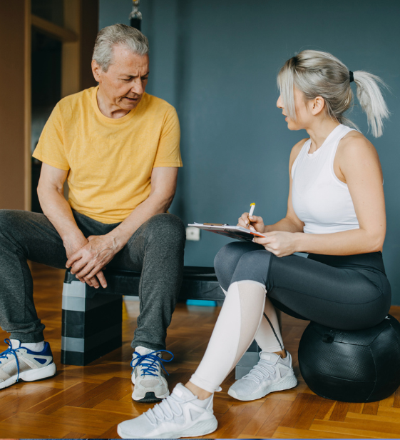 Coach supporting older adult in wellness program, emphasizing prevention and health risk management.