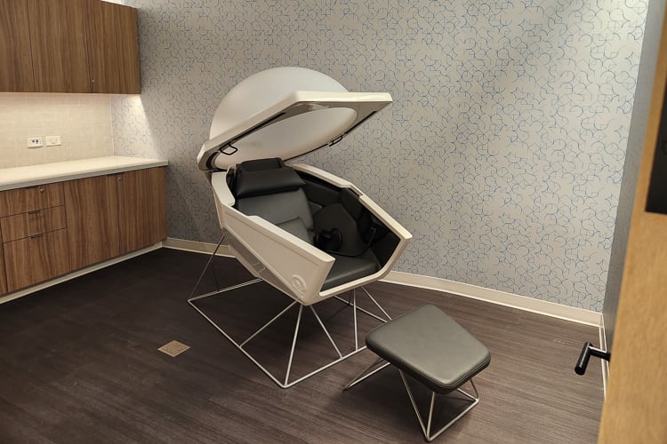 Private wellness room with a Somadome meditation pod, footrest, and built-in cabinetry.