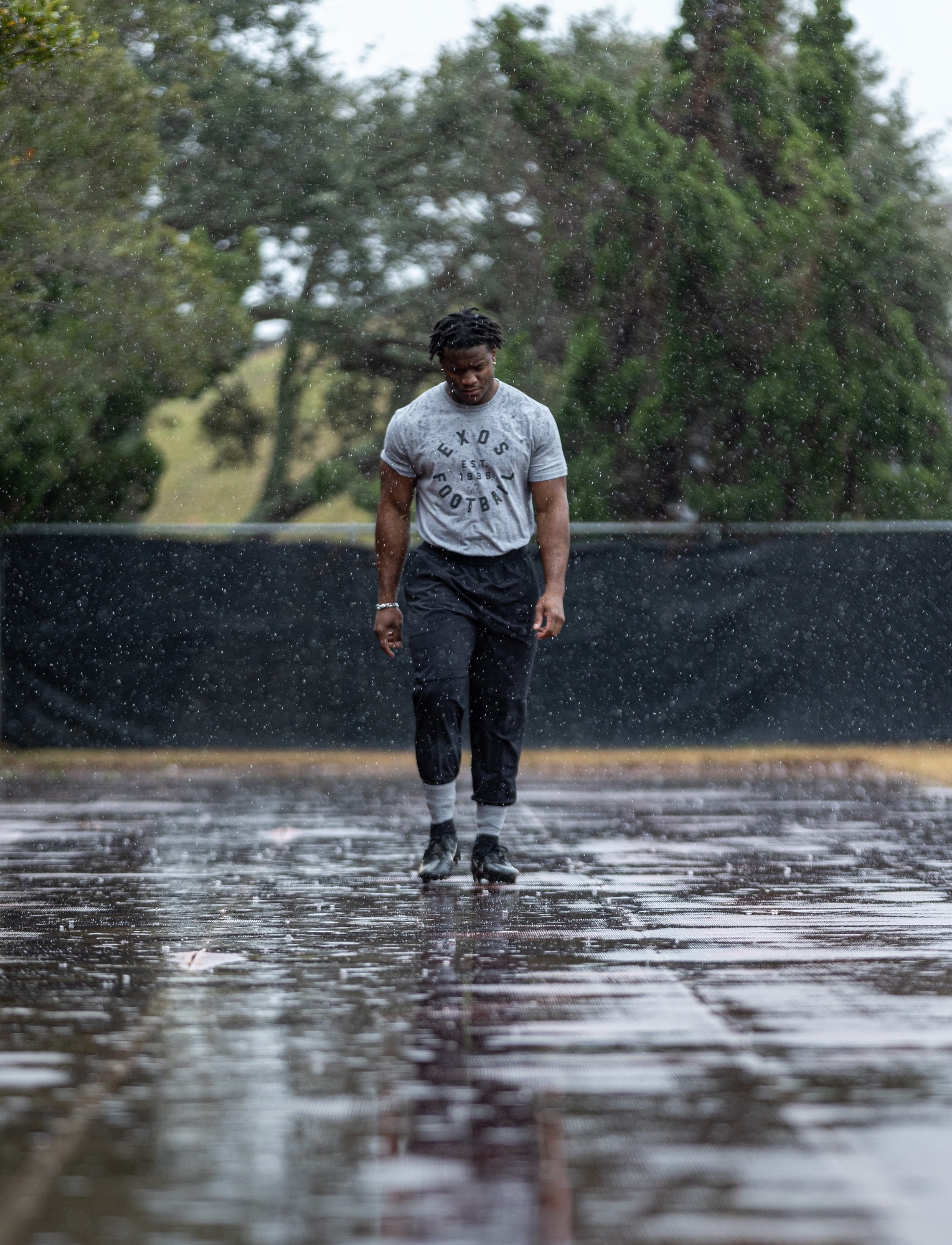 Kenneth Walker III walking in the rain at the Exos facility.