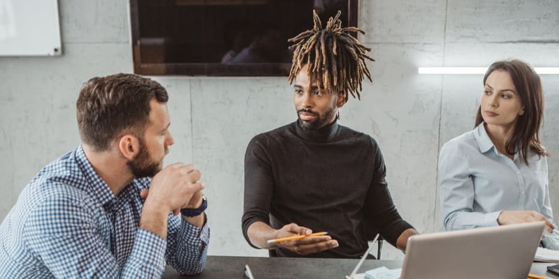 Two coworkers in a tense discussion, illustrating conflict resolution and stress management in the workplace.