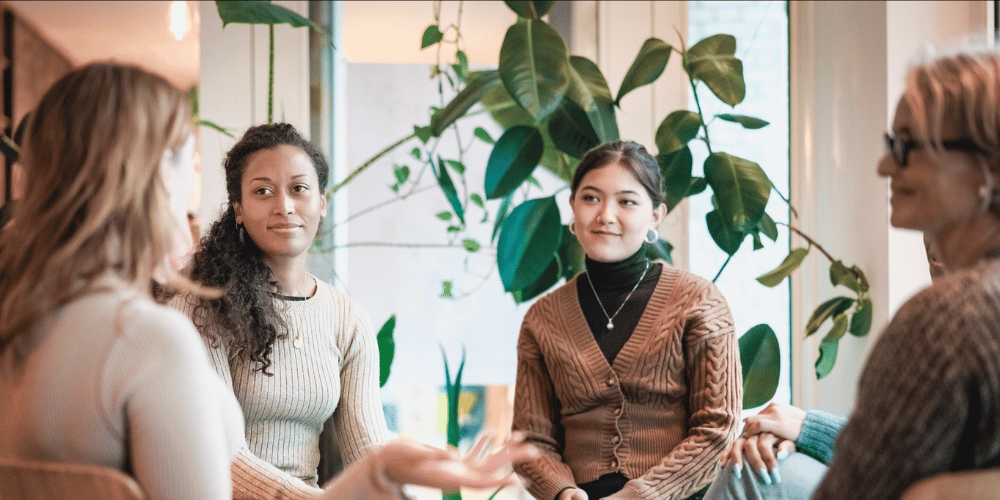 A group of women holding a meeting