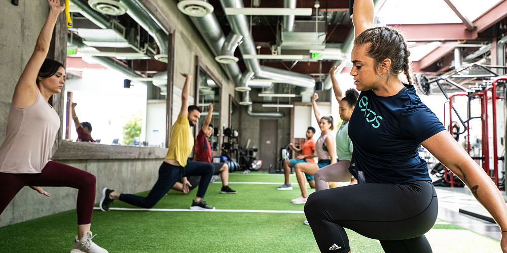 Exos trainer leads employees through a mobility session.