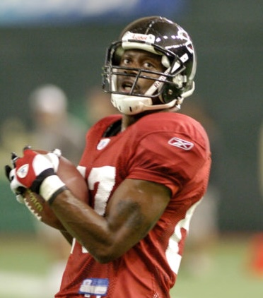 Romby Bryant holding a football