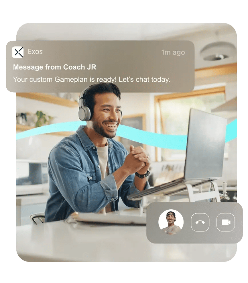Smiling man wearing headphones chats with a coach on a video call after receiving a notification that his custom Gameplan is ready.