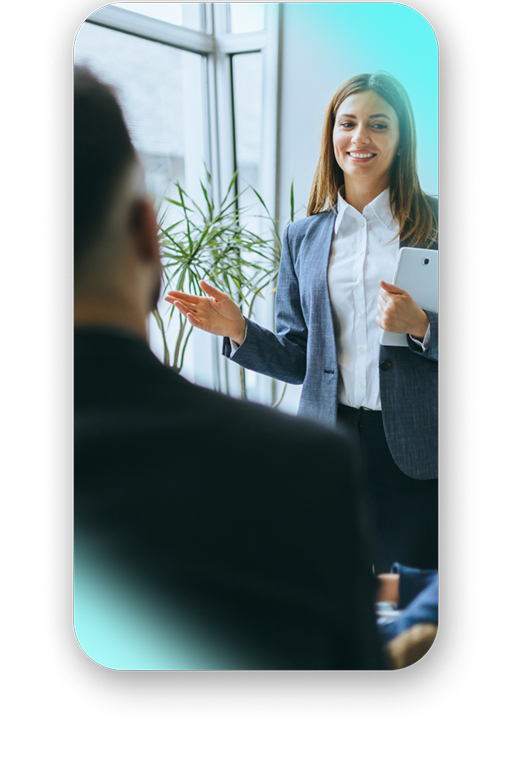 A woman in a suit presents confidently in a workshop to heighten performance..