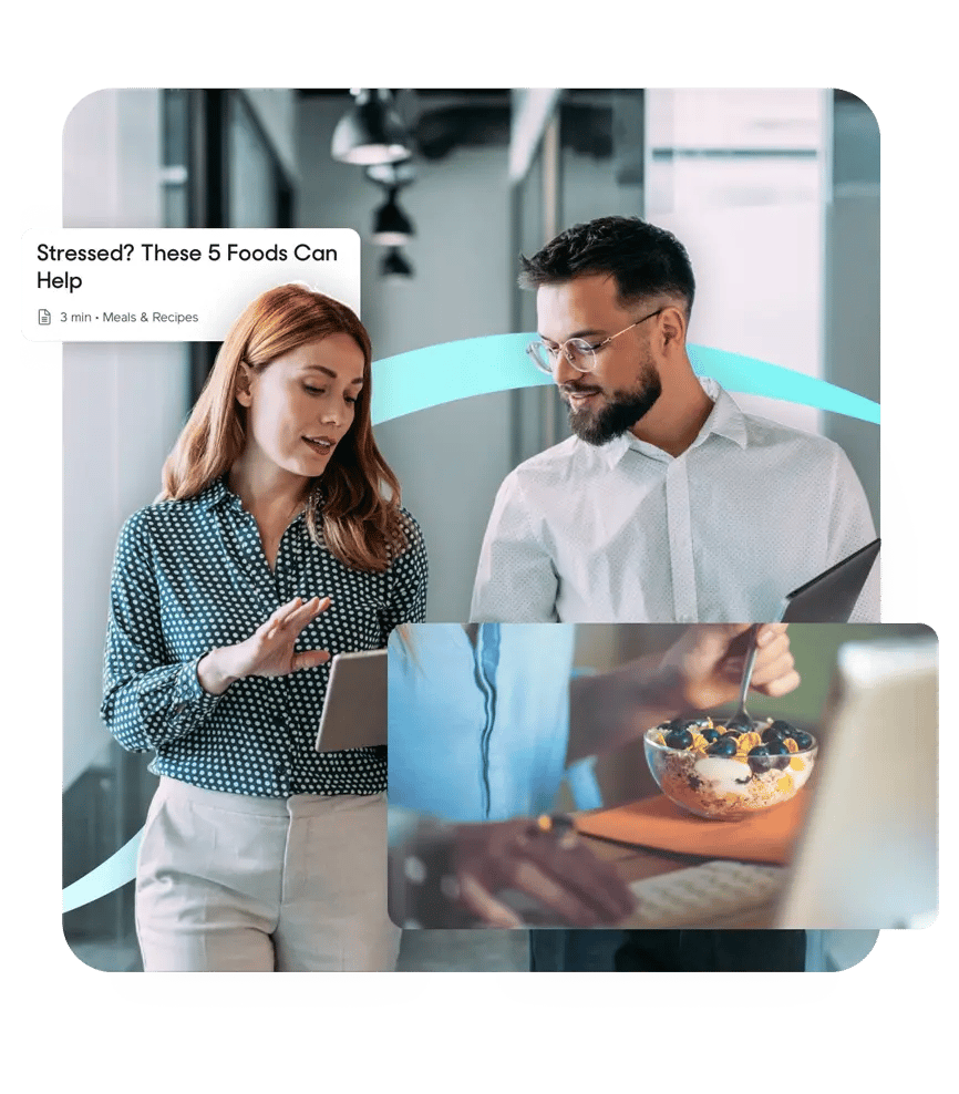 Two colleagues discuss work while holding tablets, with an inset image of a yogurt parfait topped with blueberries and granola.